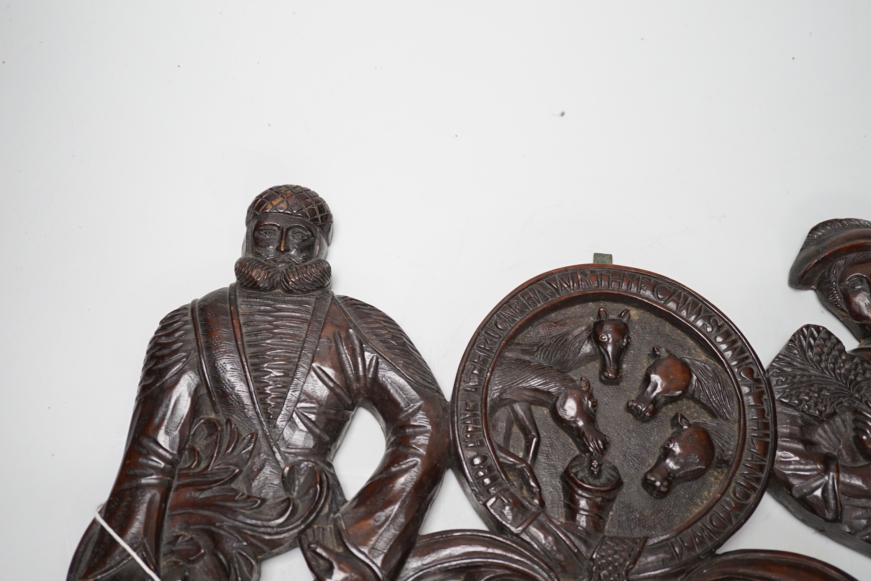 A 19th century carved figural door pediment, 46cm wide